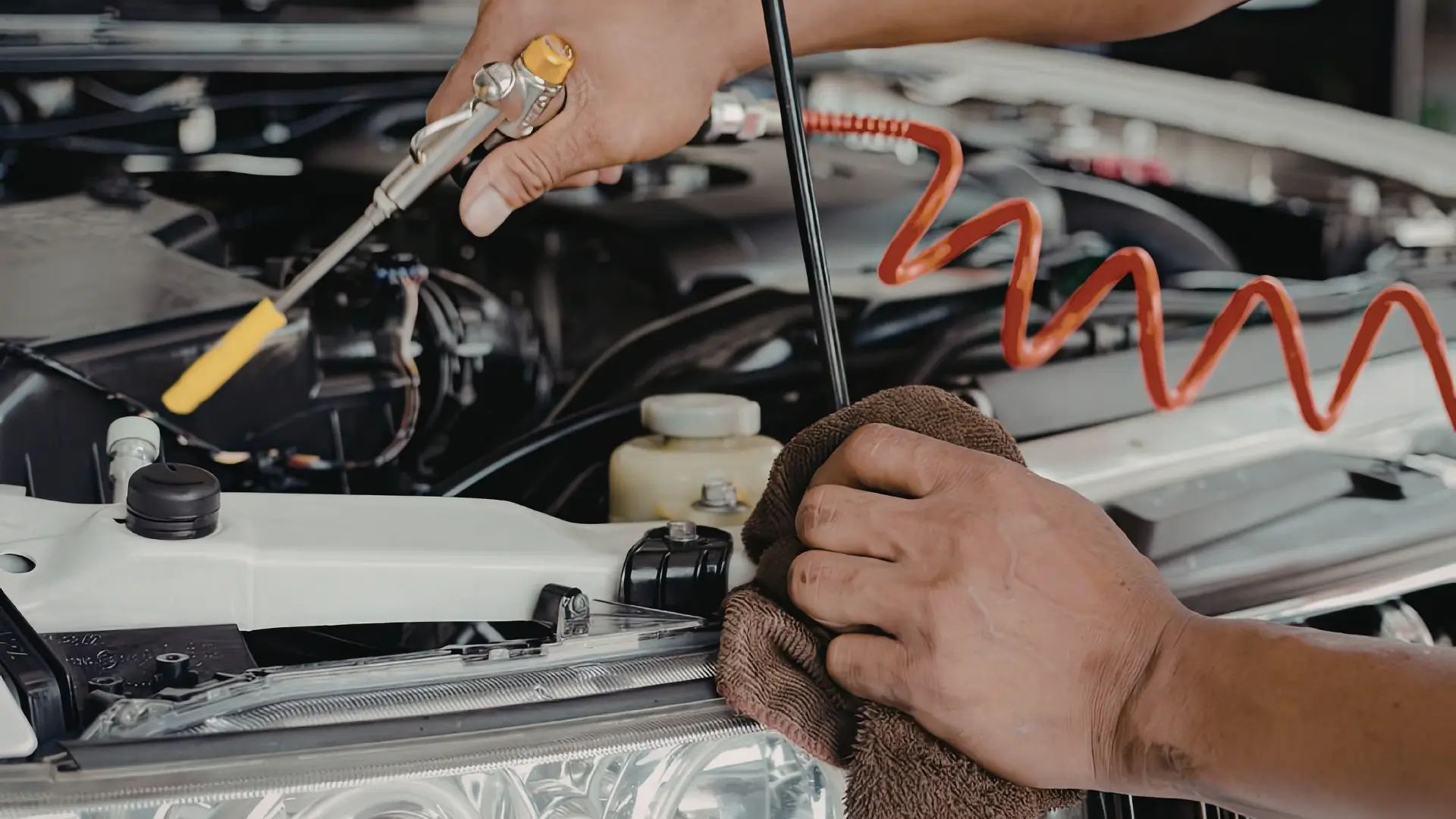 Mobile car mechanic in Dubai checking car engine for on-site repair service