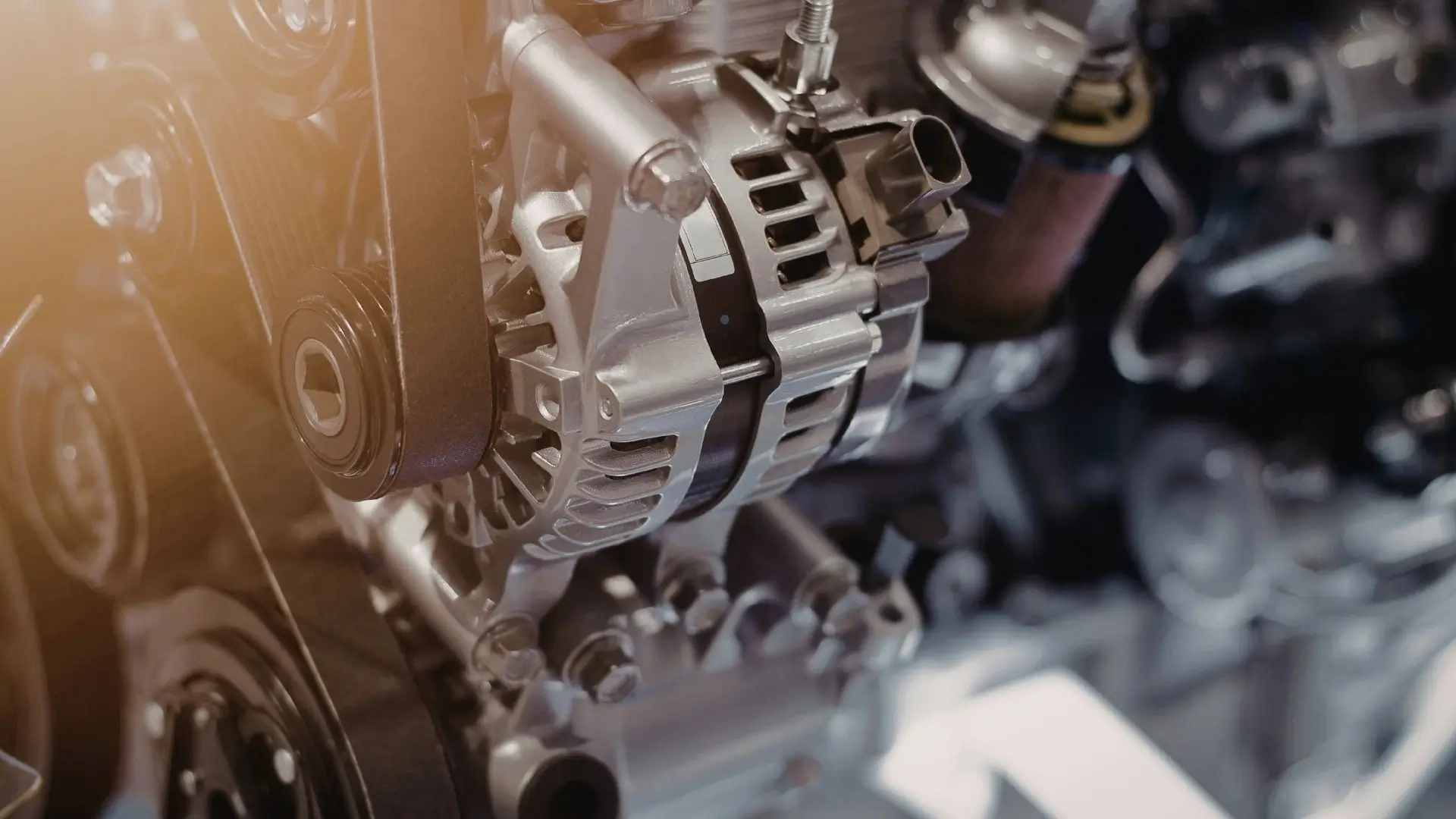 Car alternator mounted inside engine bay for charging system inspection